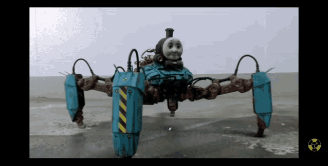 a thomas the tank engine toy is standing on a concrete floor