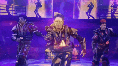 a group of people are dancing on a stage and one of them has a warning sign around his neck