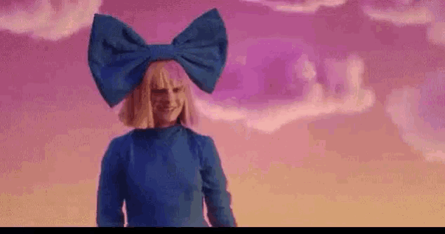 a woman with a blue bow on her head is standing in front of a cloudy sky .