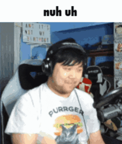 a man wearing headphones and a purrger t-shirt