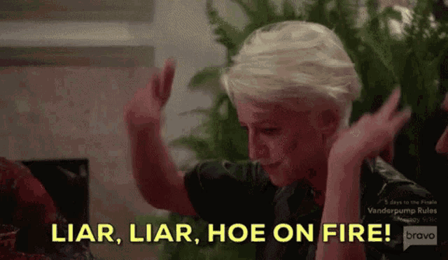 a woman is giving a high five and says liar liar hoe on fire