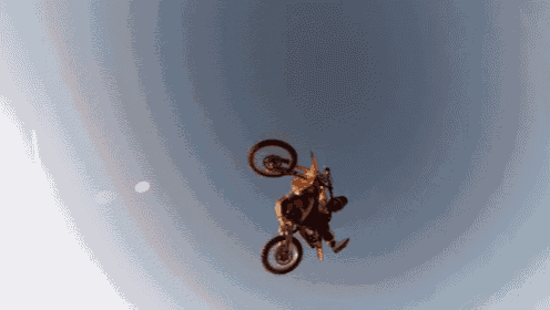 a man is doing a trick on a dirt bike in the air