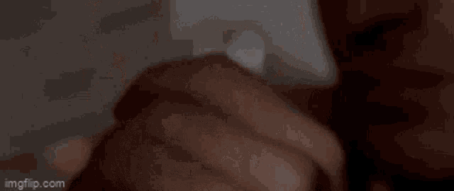 a person is holding a piece of paper with the number -1 on it