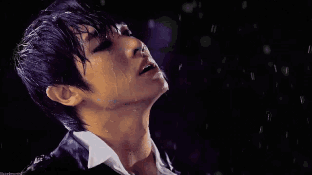 a close up of a person 's face with water coming out of their mouth