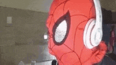a person in a spiderman costume wearing headphones .