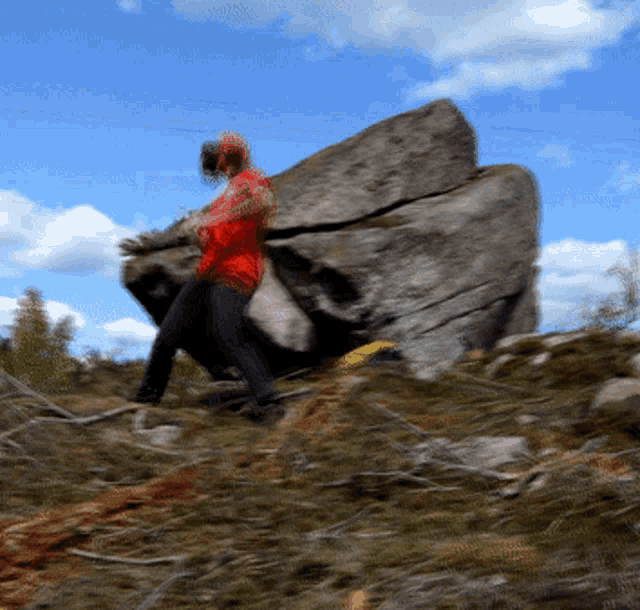 a blurry picture of a person carrying a large rock on their back