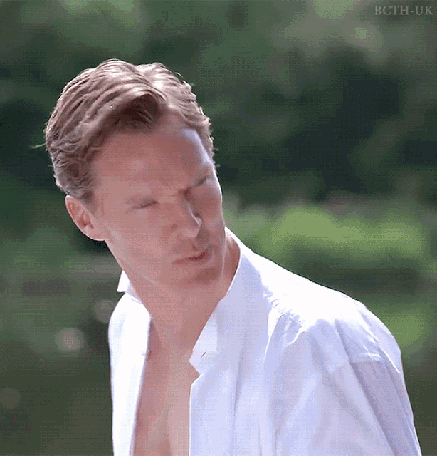 a man without a shirt is standing in front of a green background with bcth-uk on the bottom