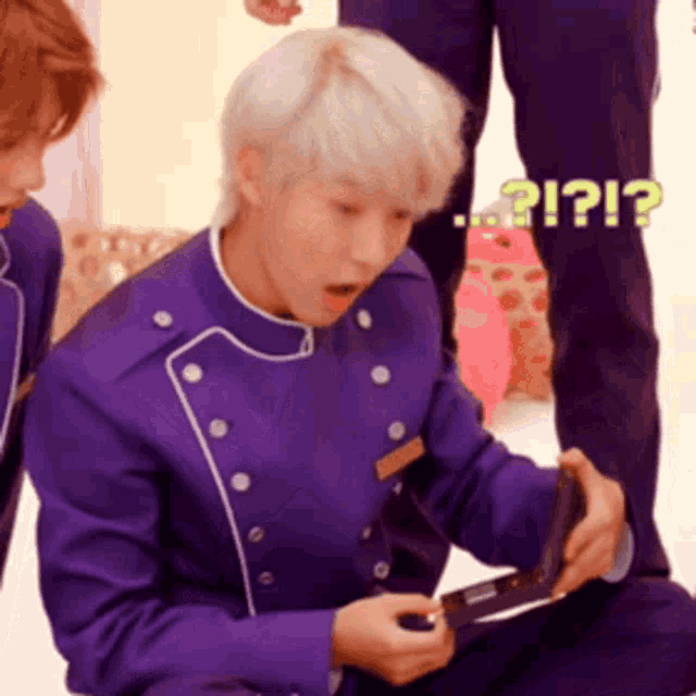 a man in a purple uniform is looking at something with a surprised expression on his face