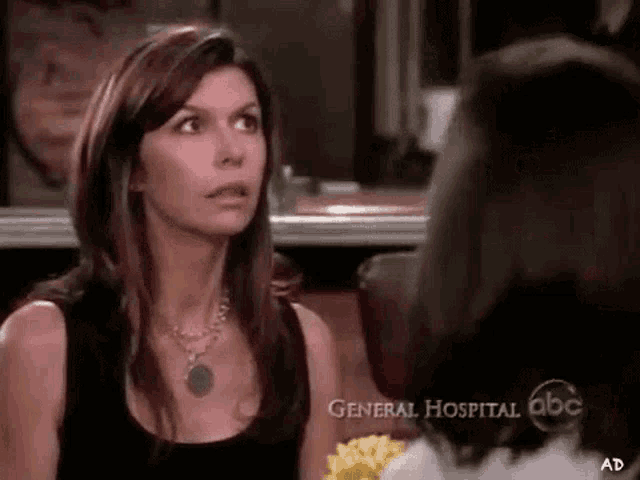 a woman in a black tank top is talking to another woman in an ad for general hospital