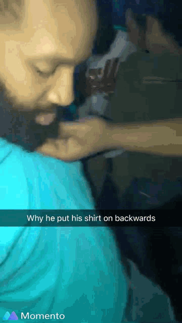 a man with a beard wearing a blue shirt with the caption why he put his shirt on backwards momento