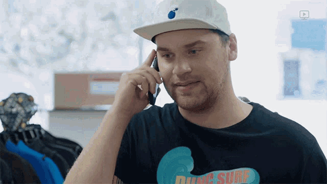 a man wearing a black shirt that says ding sure on it