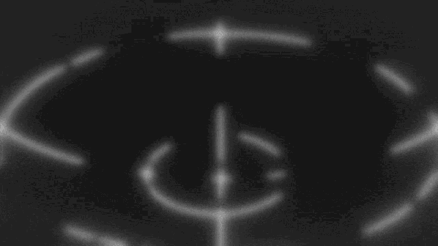 a white circle with a cross in the middle of it on a black background .