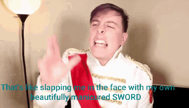 a man in a white and gold costume is giving the middle finger
