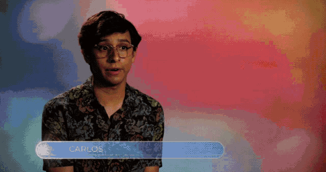 a man with glasses and the name carlos on a blue bar
