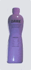 a purple bottle of dark is sitting on a white surface