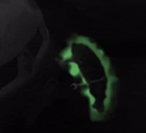 a person is working on a car with a green light coming out of the hood
