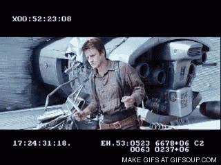 a man is standing in front of a machine that says make gifs at gifsoup.com at the bottom