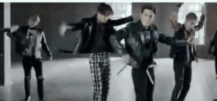 a group of men are dancing together in a room .