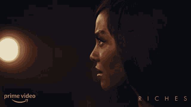 a woman in a dark room with the word jesus on the bottom right