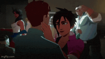 a group of people are standing around a man in a blue shirt