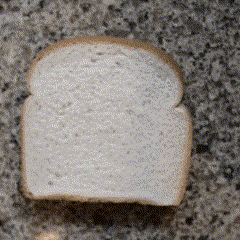 a slice of white bread is sitting on a granite counter