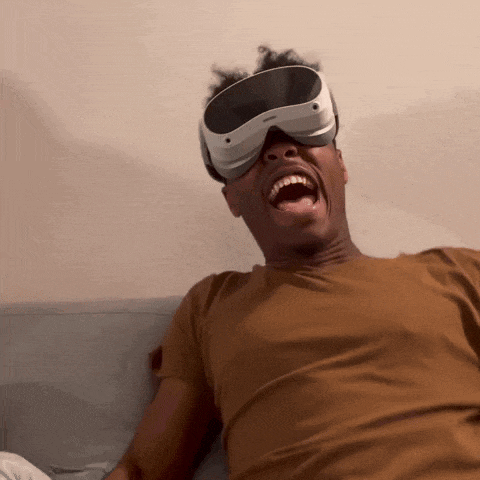 a man wearing an oculus virtual reality headset is laughing