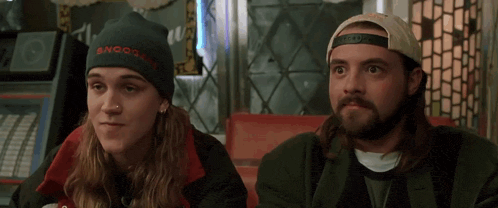 a man wearing a beanie that says snooze