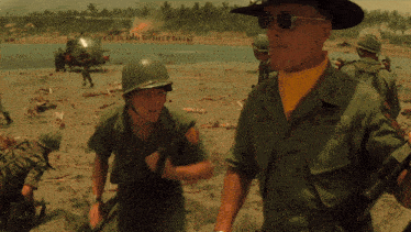 a man in a green u.s. army uniform is standing next to another man