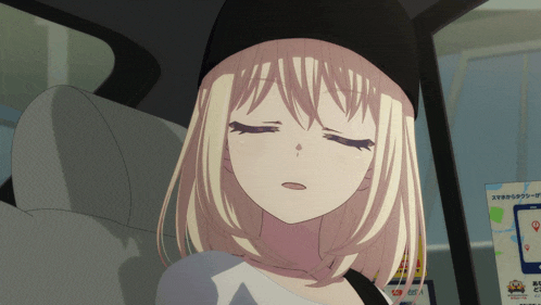 a girl with blonde hair and a black hat is sitting in the back seat of a car