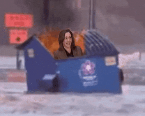 a woman is sitting inside of a blue trash can .