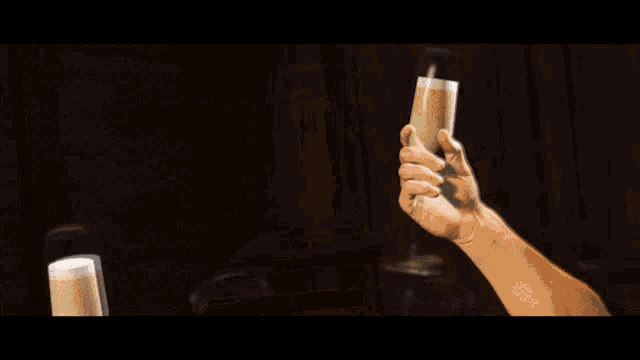 a group of people toasting with champagne glasses in a dark room