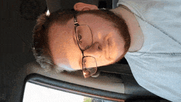 a man with glasses and a beard is laying down