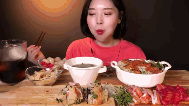 a woman in a red shirt is eating a variety of food
