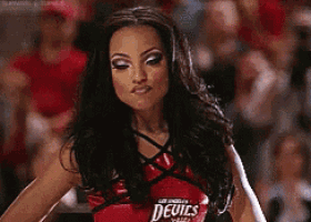 a cheerleader for the devils is standing in front of a crowd