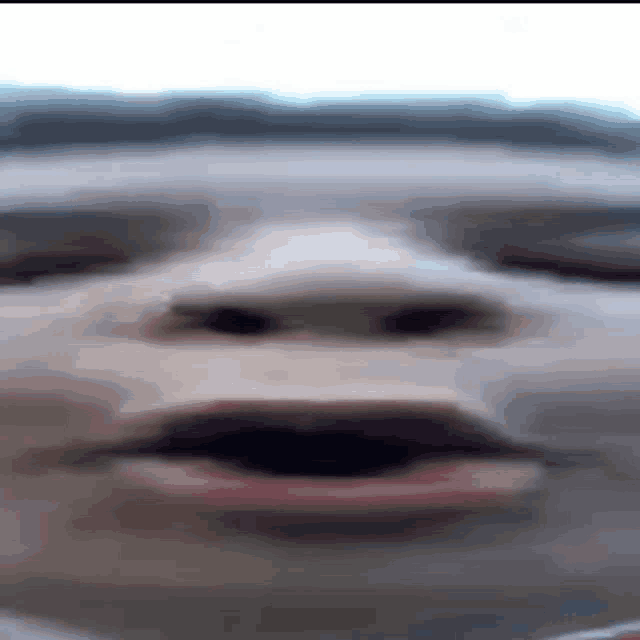 a blurry picture of a person 's face with a mustache and red lips .