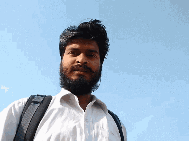 a man with a beard wearing a white shirt