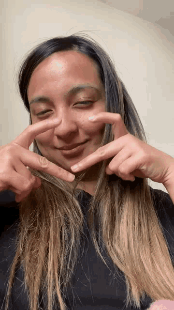 a woman making a peace sign with her hands
