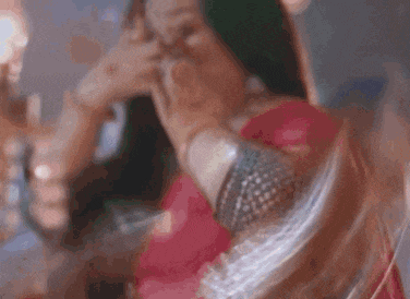 a woman is taking a picture of herself with her phone .