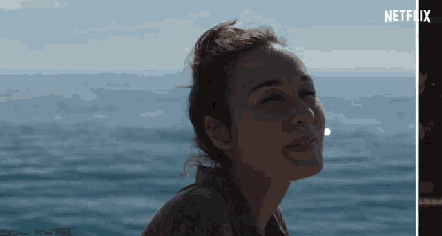 a netflix advertisement shows a woman looking at the ocean
