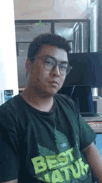 a man wearing glasses and a t-shirt that says best natur