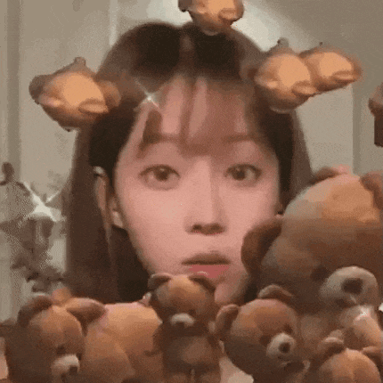 a woman is surrounded by teddy bears and has a sticker on her face .