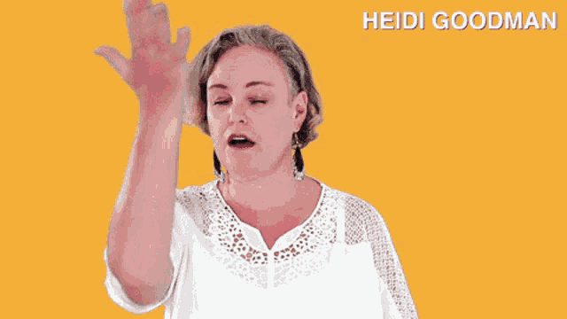 a woman in a white shirt with the name heidi goodman on the bottom right