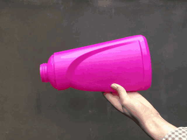 a person is holding a pink bottle with a label that says 1 liter on it