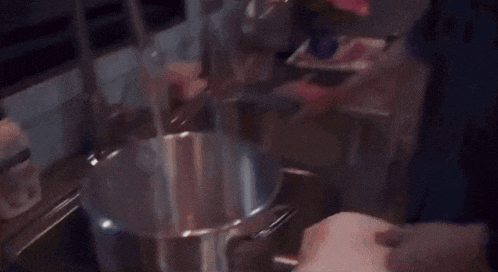 a young man is pouring a bottle of diet coke into a pot ..