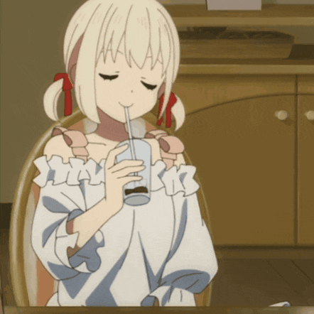 a girl drinking through a straw from a cup