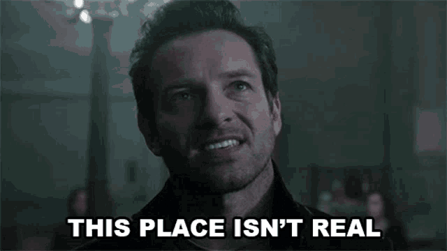 a man making a face with the words " this place isn 't real " behind him