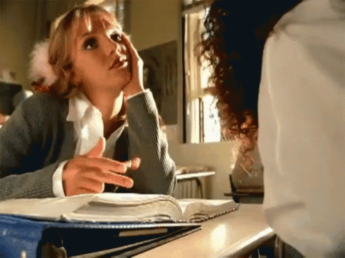 a woman sitting at a desk with a book on it