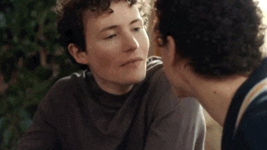 a man and a woman are kissing each other .