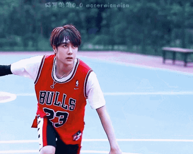 a man wearing a bulls 23 jersey stands on a court