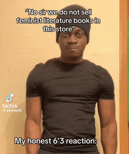 a man wearing a black shirt and a black beanie says no sir we do not sell feminist literature books in this store